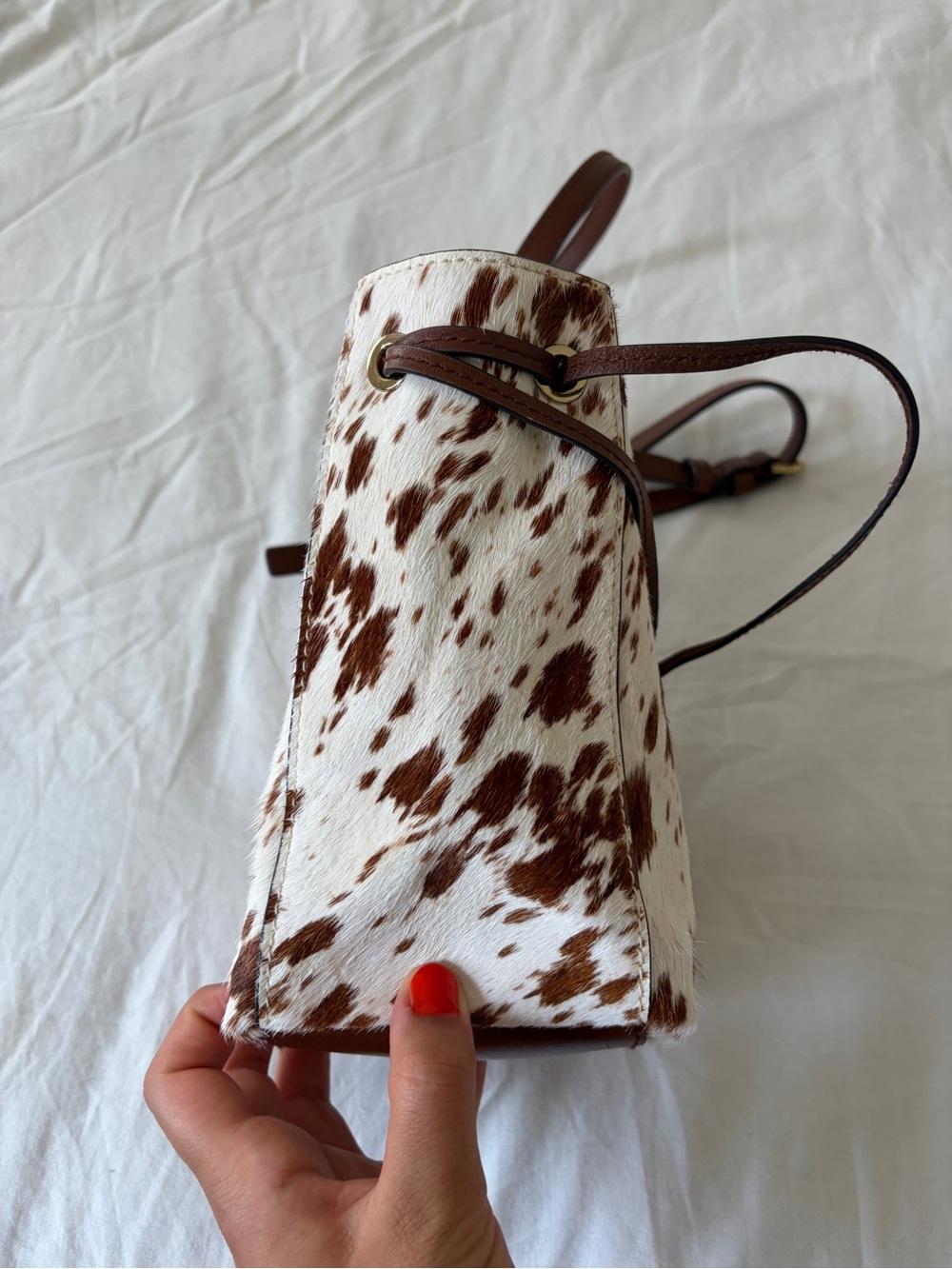 The Mini Drawstring Crossbody Bucket Bag Cow Print - Picture 5 of 11